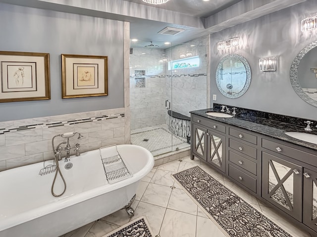 full bathroom featuring a stall shower, marble finish floor, a sink, and a soaking tub