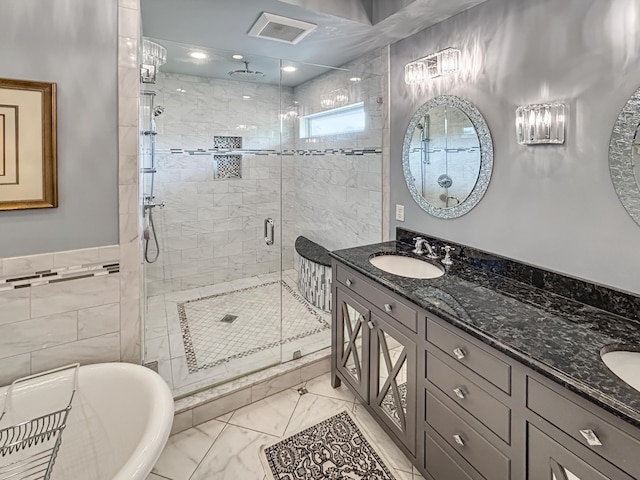 bathroom featuring double vanity, a sink, a shower stall, and visible vents