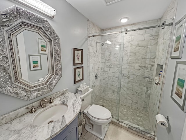 bathroom with a shower stall, toilet, and vanity