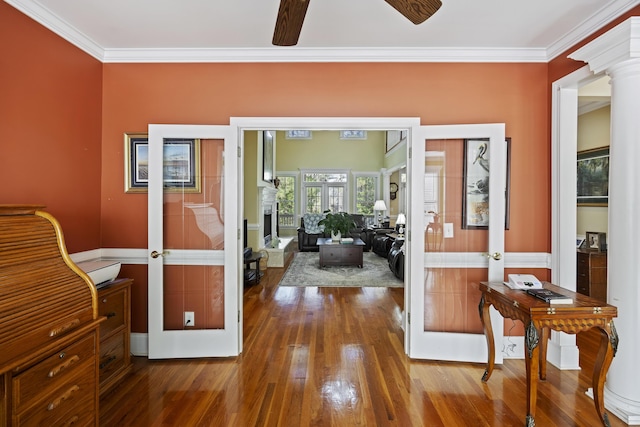 office space featuring crown molding, ceiling fan, hardwood / wood-style flooring, french doors, and ornate columns