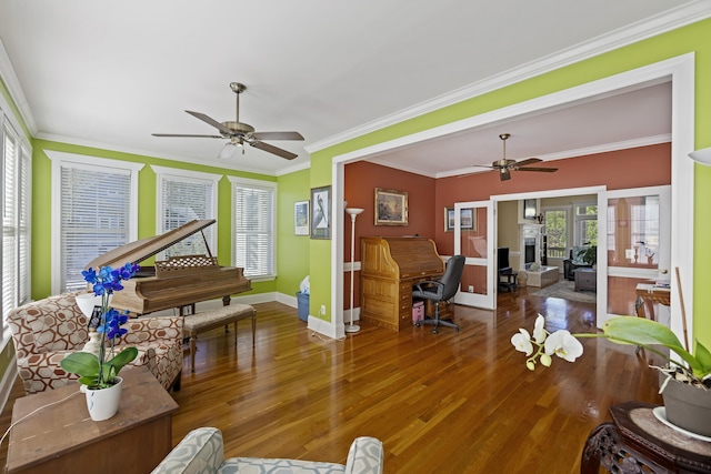 living room with ceiling fan, ornamental molding, and hardwood / wood-style floors