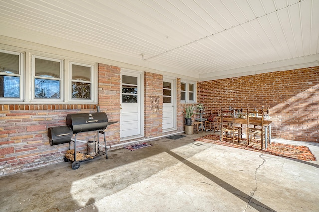 view of patio featuring a porch and a grill