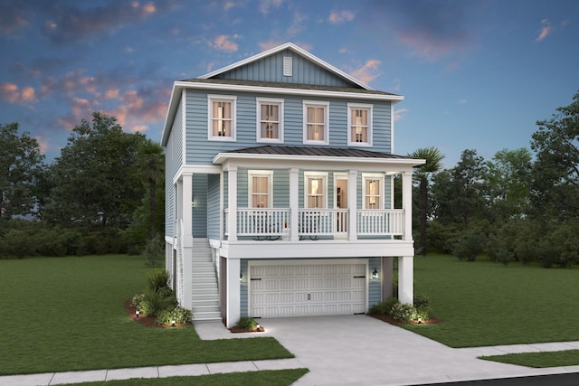 view of front facade with a lawn, covered porch, and a garage