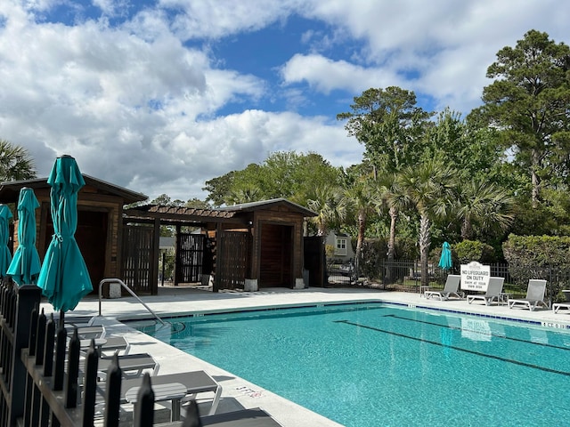 view of swimming pool with a pergola and a patio