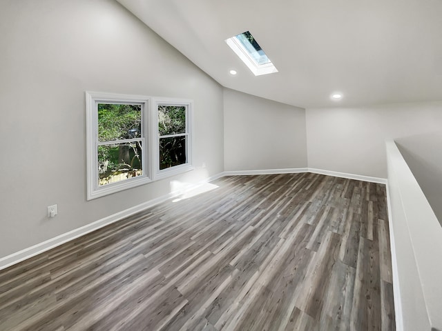 bonus room with wood-type flooring and lofted ceiling with skylight