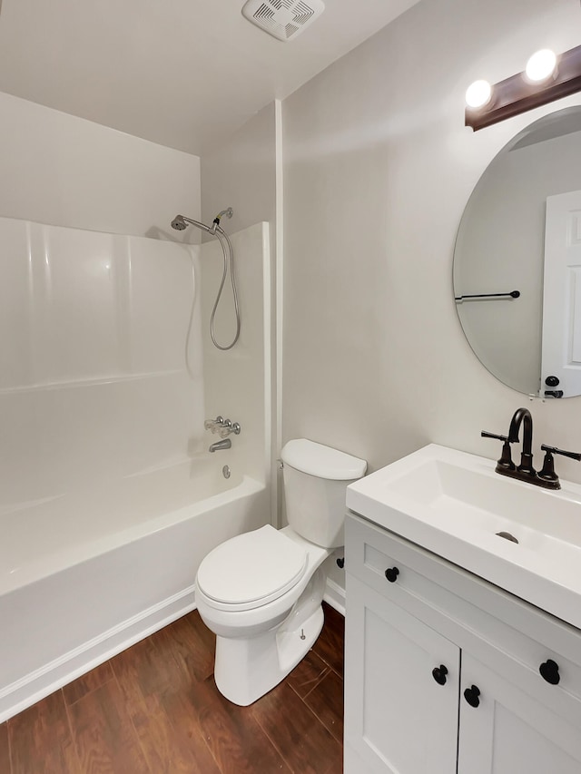 full bathroom featuring wood-type flooring, toilet, shower / washtub combination, and vanity