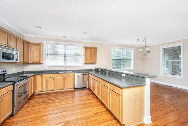 2301 N Creek Dr, Mount Pleasant, SC 29466 - kitchen with appliances with stainless steel finishes, a peninsula, dark countertops, light wood-style floors, and ornamental molding