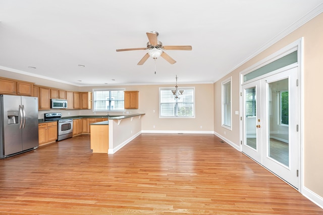 2301 N Creek Dr, Mount Pleasant, SC 29466 - kitchen with stainless steel appliances, light wood-type flooring, a kitchen bar, crown molding, and ceiling fan