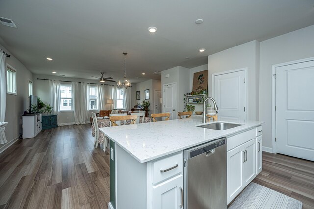 kitchen with dishwasher, sink, light wood-type flooring, and a kitchen island with sink