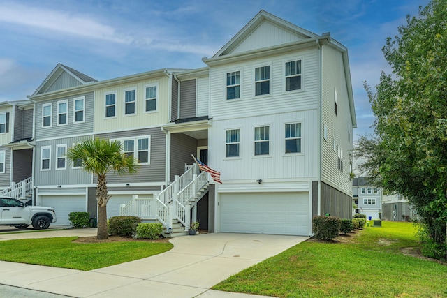 view of front of home featuring stairway, an attached garage, concrete driveway, and a front lawn
