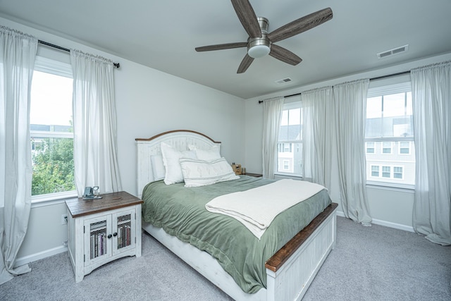 bedroom featuring light colored carpet, visible vents, and baseboards