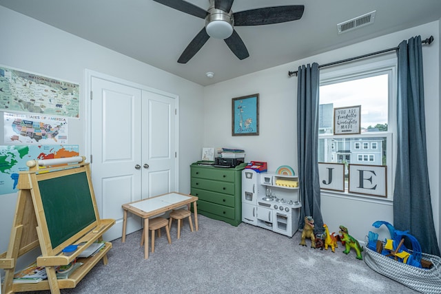 playroom with visible vents, carpet, and a ceiling fan
