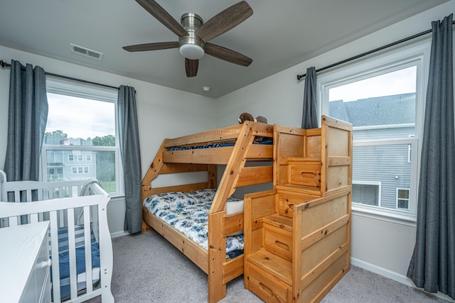 bedroom featuring ceiling fan, baseboards, visible vents, and light carpet