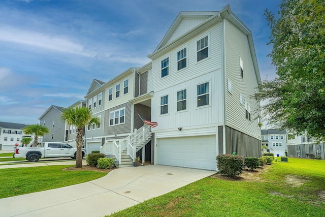 view of front facade with a residential view, concrete driveway, a front lawn, and a garage