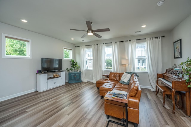 living area featuring a healthy amount of sunlight, visible vents, and light wood-type flooring