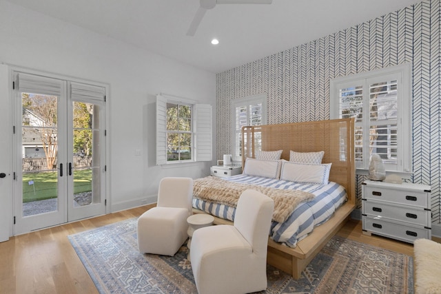 bedroom featuring recessed lighting, wood finished floors, baseboards, access to outside, and wallpapered walls