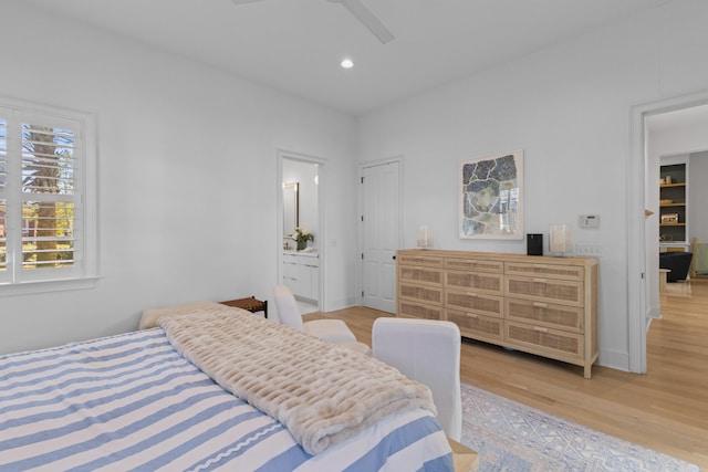 bedroom with recessed lighting, baseboards, ensuite bath, and light wood finished floors