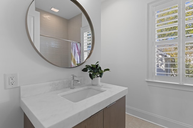 full bathroom with curtained shower, vanity, and baseboards