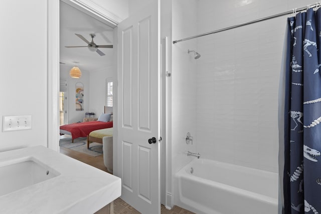 ensuite bathroom with a ceiling fan, a sink, shower / bathtub combination with curtain, and ensuite bath