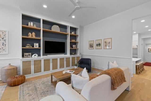 living room with built in features, recessed lighting, ceiling fan, and wood finished floors