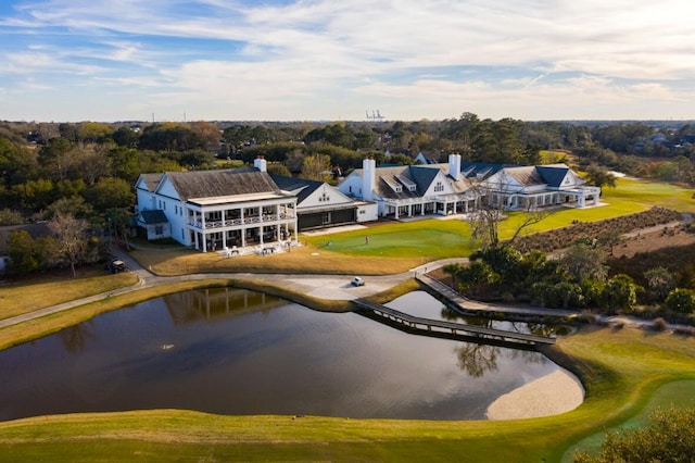 birds eye view of property with view of golf course and a water view