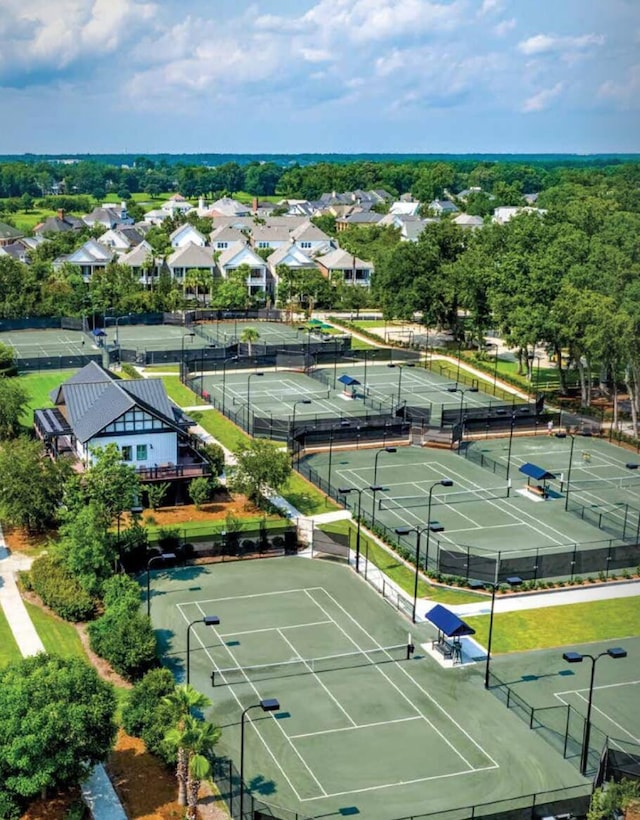 view of tennis court with a residential view