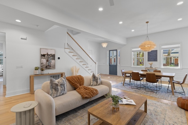 living area featuring stairs, a wainscoted wall, light wood-type flooring, and recessed lighting