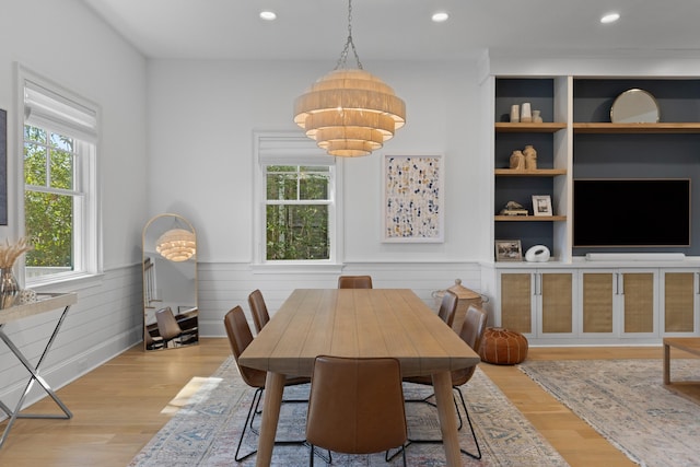 dining room with recessed lighting, light wood-style flooring, and wainscoting