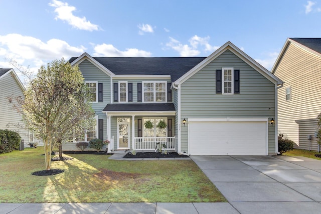 view of front of house featuring a porch, driveway, an attached garage, and a front yard