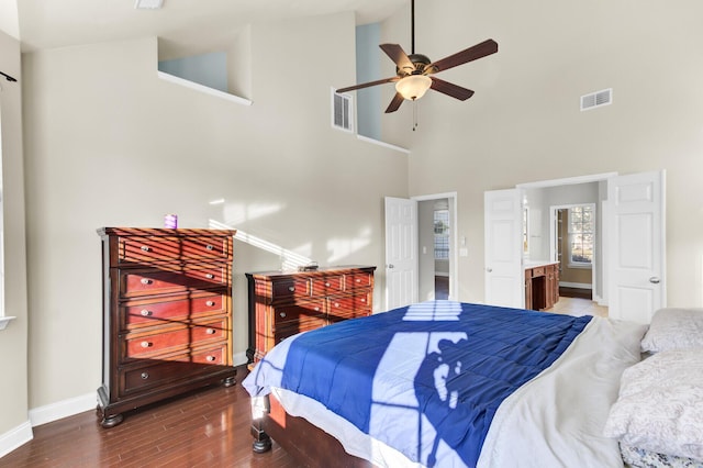 bedroom featuring visible vents, a ceiling fan, baseboards, and wood finished floors