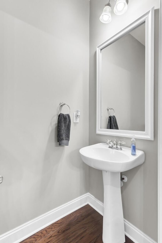 bathroom with baseboards and wood finished floors