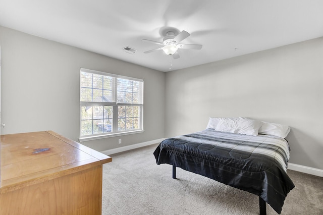 bedroom featuring visible vents, baseboards, a ceiling fan, and carpet flooring