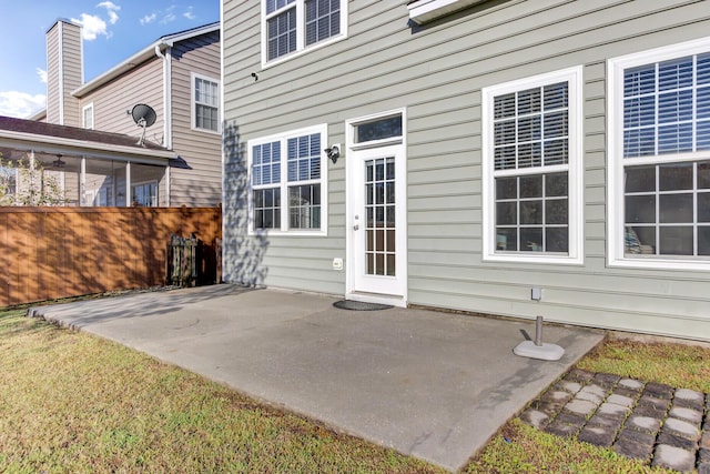 rear view of property with a patio and fence