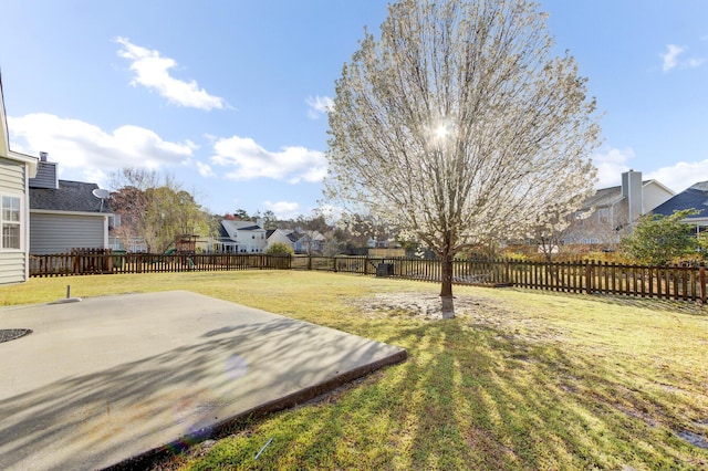 view of yard featuring a patio area, a residential view, and a fenced backyard