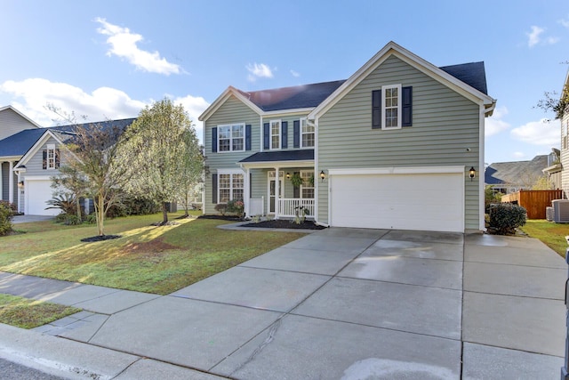 traditional-style house featuring fence, driveway, covered porch, a front lawn, and a garage