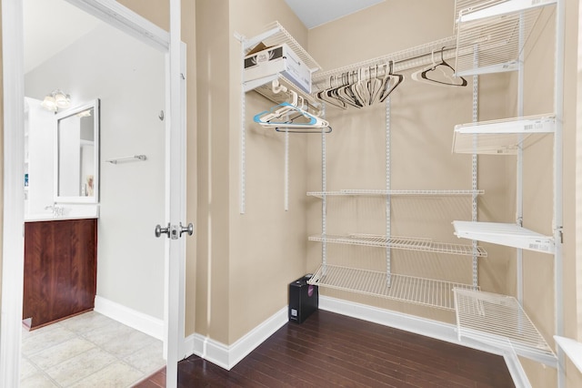 walk in closet featuring wood finished floors