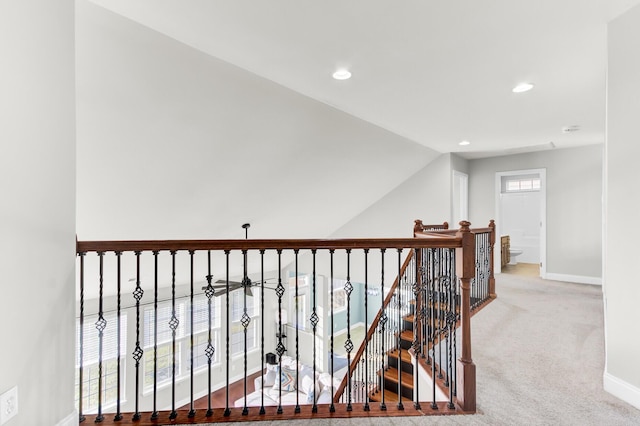 hall featuring baseboards, carpet floors, recessed lighting, vaulted ceiling, and an upstairs landing