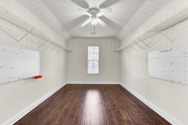 walk in closet with lofted ceiling, ceiling fan, and hardwood / wood-style flooring