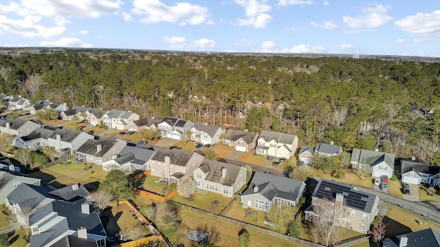 drone / aerial view with a residential view and a wooded view