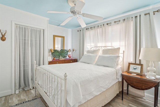 bedroom with ceiling fan and light wood-type flooring