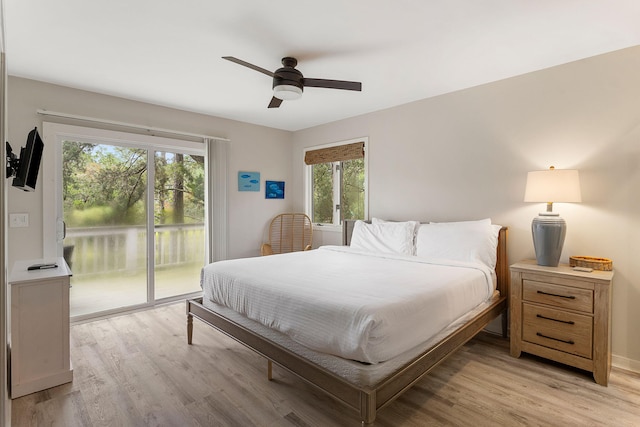 bedroom featuring access to exterior, light wood finished floors, and a ceiling fan