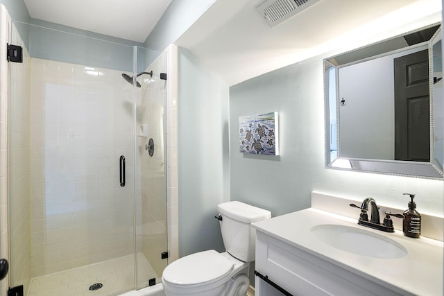 full bathroom featuring toilet, a shower stall, visible vents, and vanity