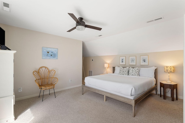 carpeted bedroom featuring lofted ceiling and visible vents