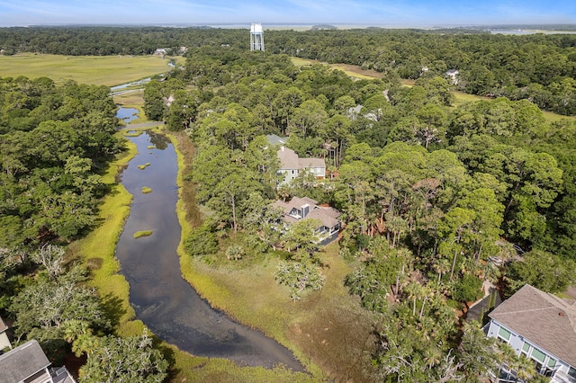 aerial view featuring a forest view and a water view