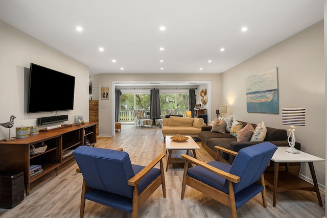 living room with light wood-type flooring, baseboards, and recessed lighting