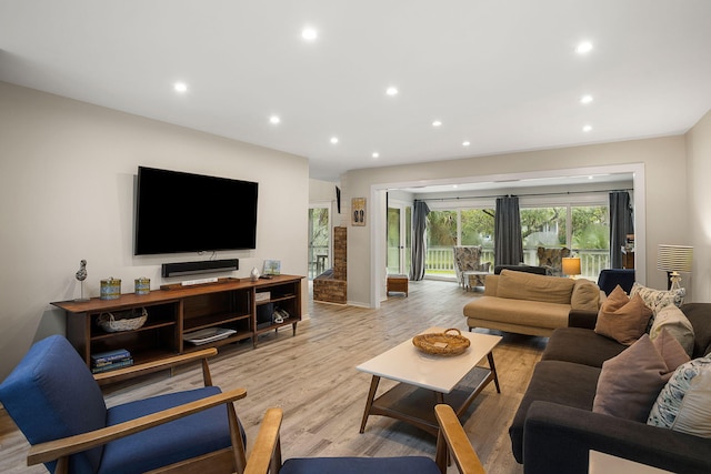 living room with light wood-type flooring and recessed lighting