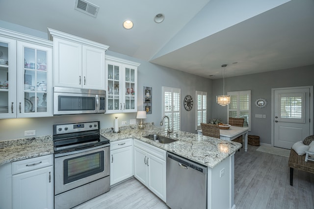 kitchen with stainless steel appliances, white cabinets, and sink