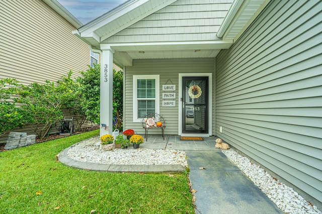 property entrance with a lawn and a porch