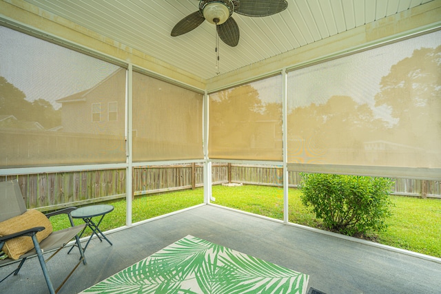 unfurnished sunroom with ceiling fan