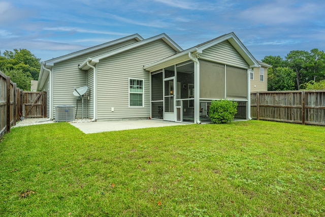 back of house featuring a sunroom, central AC unit, a patio area, and a yard